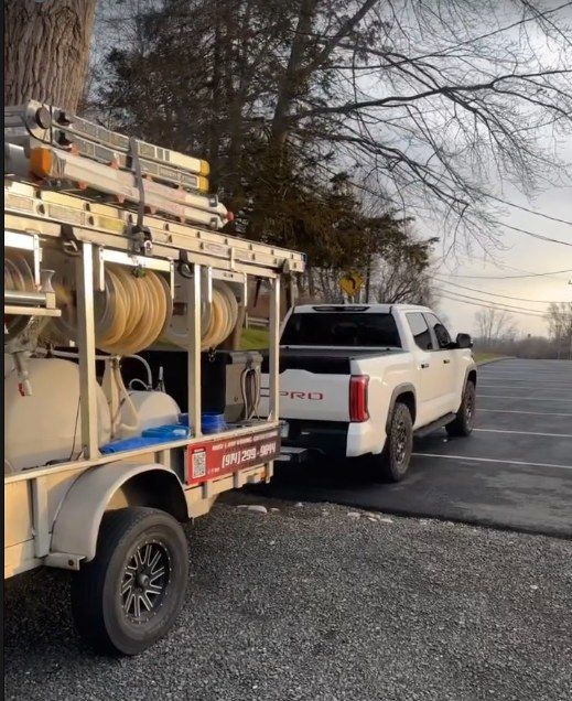Jerry's truck and equipment trailer on a jobsite